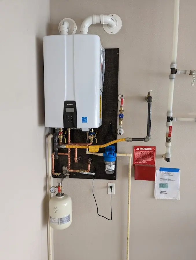 Professional plumber installing copper piping in a Grants home